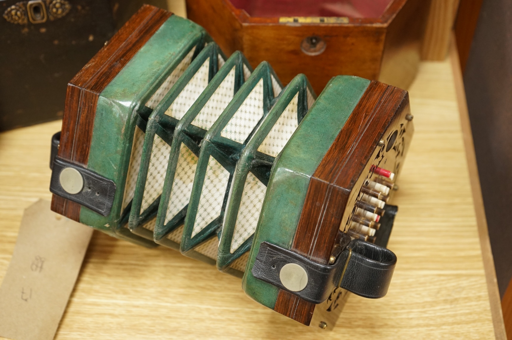 A mahogany cased concertina by Rock Chidley, 135, High Holborn, London, with the rosewood body and numbered 566, CITES Submission reference QML3VKXT